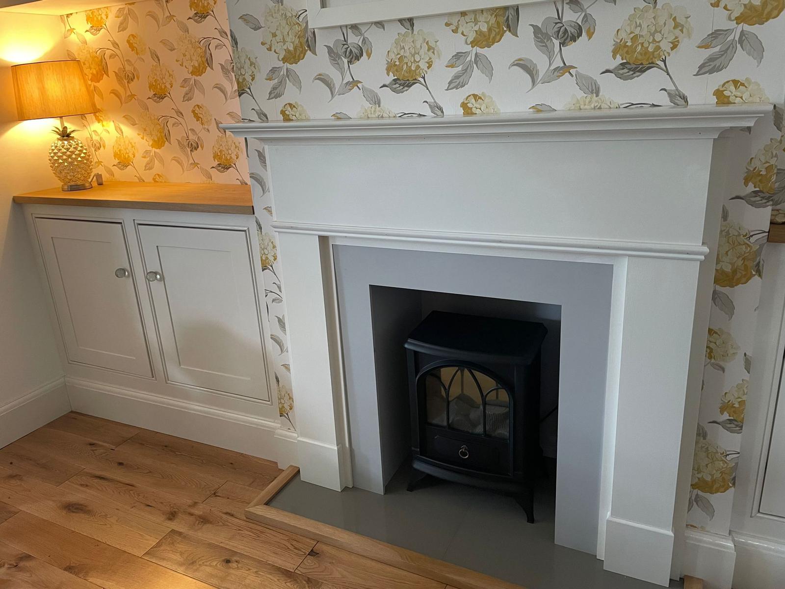 making of fitted cupboards and fire surround. Includes new flooring and wallpapering.