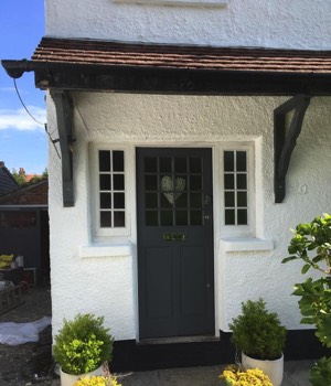 making, fitting and painting of front door and fitting of new windows.